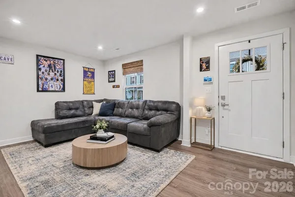 a living room with furniture and painting on the wall