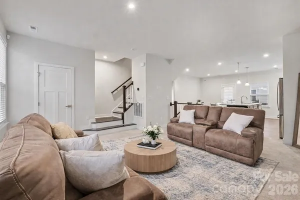 a living room with furniture and white walls
