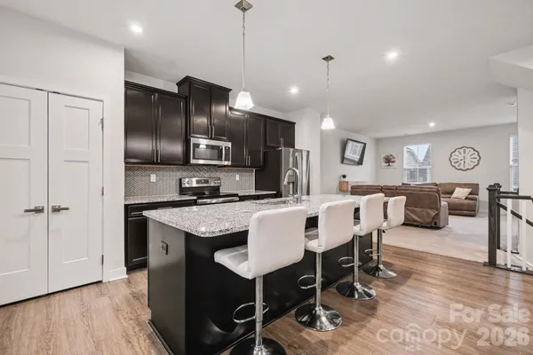 a large kitchen with a table and chairs