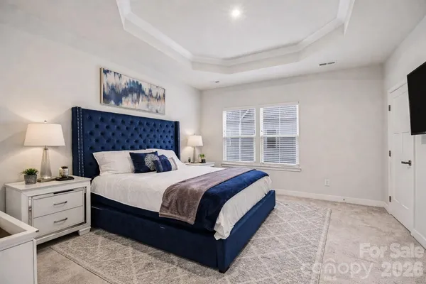 a bedroom with a large bed and a window