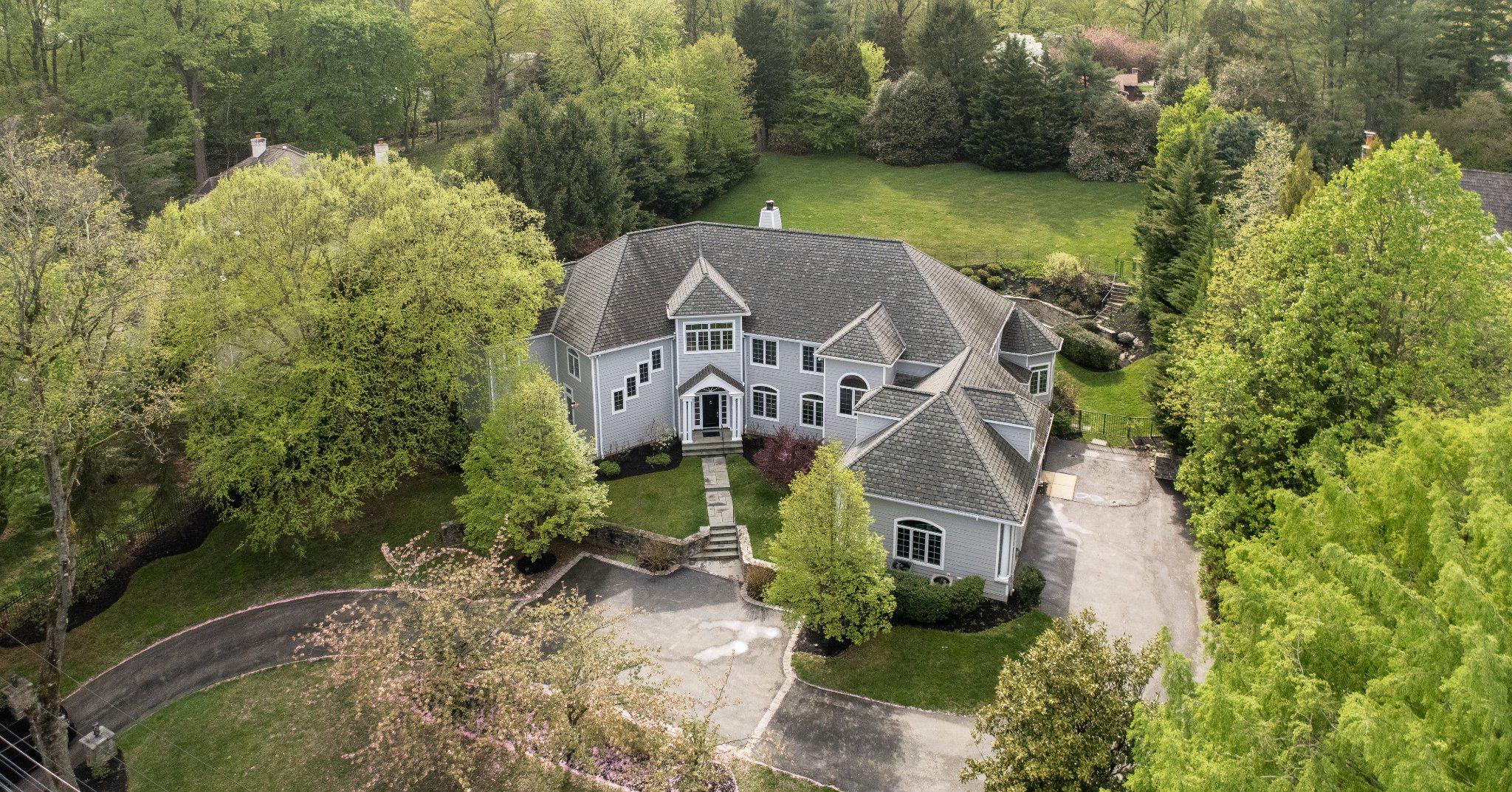 Front exterior nestled in lush greenery