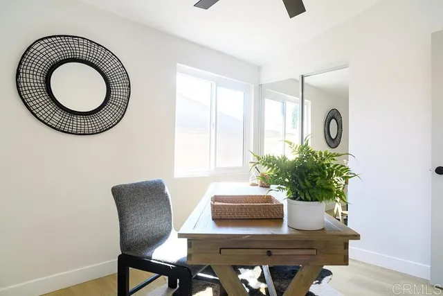 a dining room with furniture and a potted plant