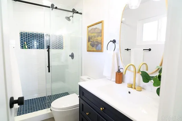 a bathroom with a sink toilet and shower