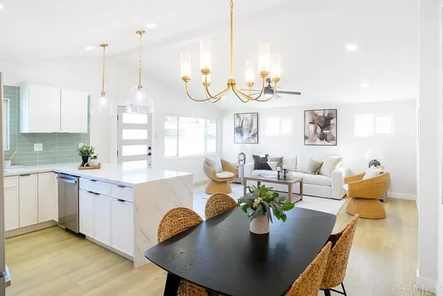 a living room with granite countertop kitchen island furniture and a chandelier