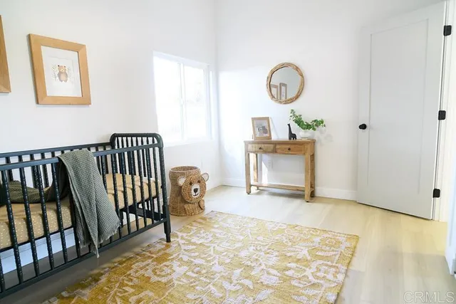 a view of a room with furniture and wooden floor