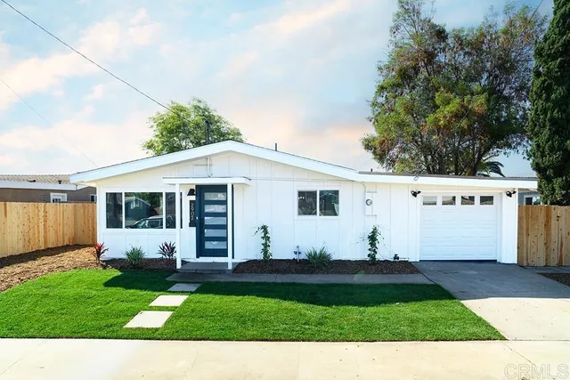 a view of a backyard with potted plants and large tree
