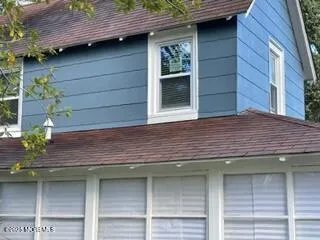 a view of brick house with a large window