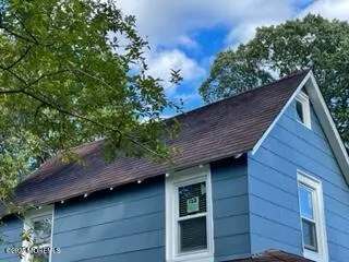a view of front door of house with a yard