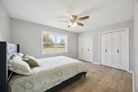 a bedroom with a large bed and a window