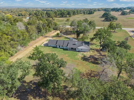 an aerial view of a house with a lake view