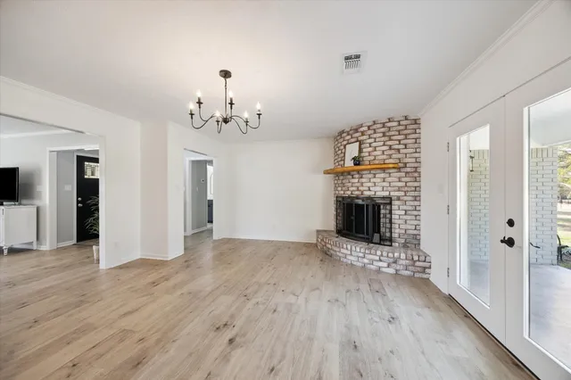 wooden floor in an empty room with a fireplace