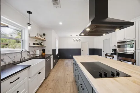 a kitchen with a stove a sink and a refrigerator