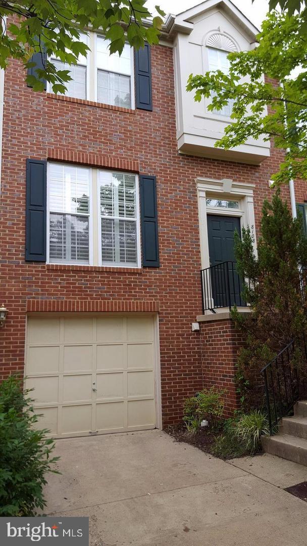 front view of a brick house with a yard