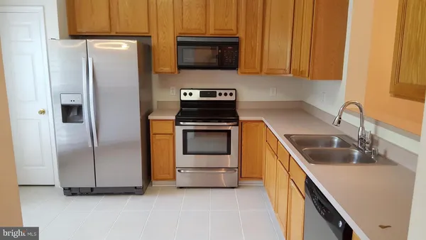 a kitchen with a refrigerator sink and stove