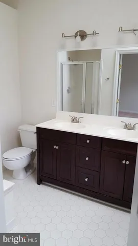 a bathroom with a sink vanity and a mirror
