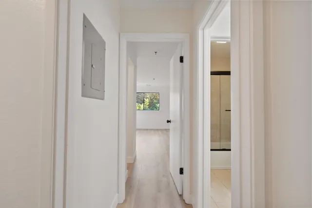 a view of a hallway with wooden floor