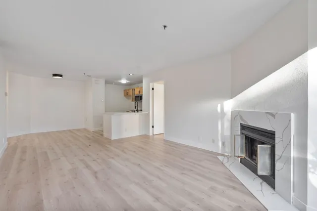a view of empty room with a fireplace