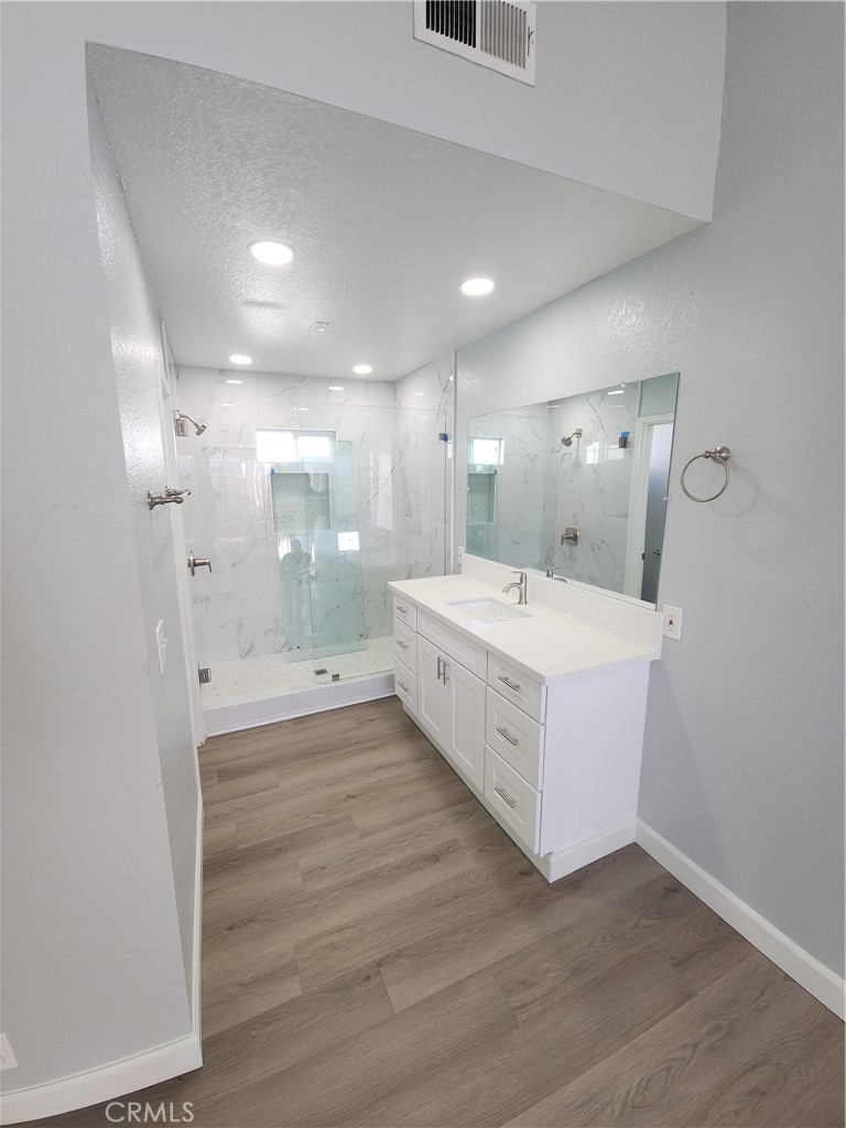 a bathroom with a double vanity sink and a mirror