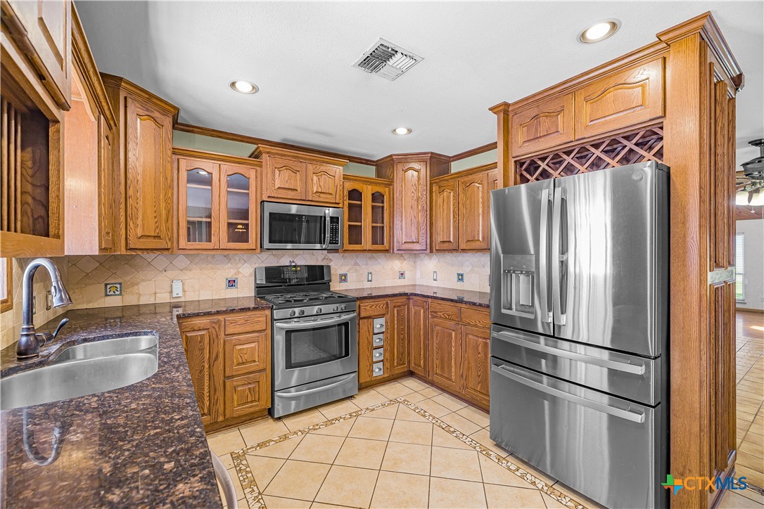 20 Hambleton Road Victoria, TX 77905 - Photo 4 of 48 a kitchen with stainless steel appliances granite countertop a refrigerator stove top oven and sink