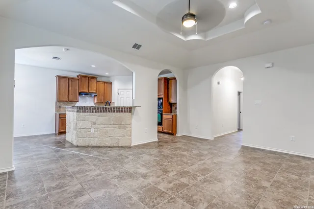 wooden floor in an empty room with a kitchen