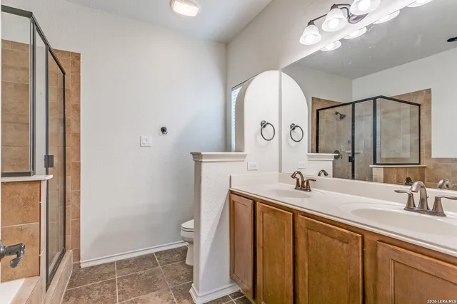 a bathroom with a sink a toilet and a mirror