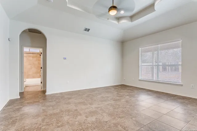 an empty room with windows and closet