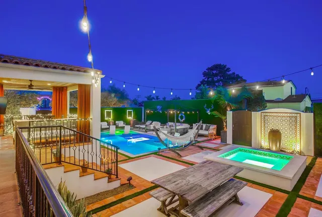 a view of a patio with dining table and chairs with a fire pit