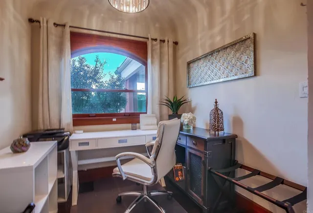 a living room with furniture and a floor to ceiling window