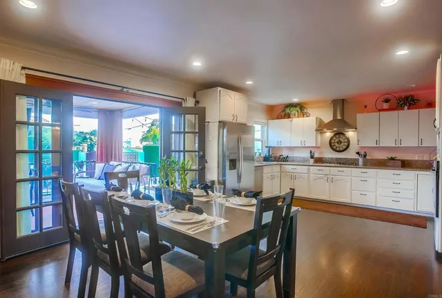 a kitchen with granite countertop white cabinets and stainless steel appliances