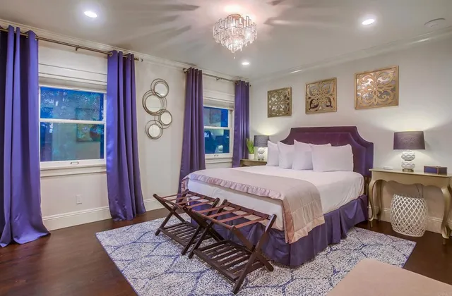 a bedroom with a bed and a painting on the wall