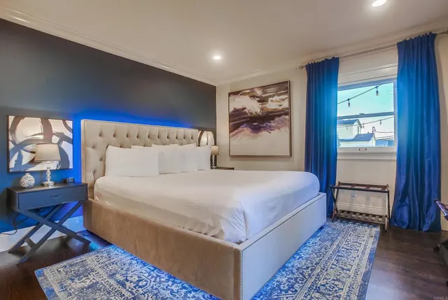 a bedroom with a large bed and a chandelier