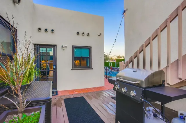 a view of a patio with dining table and chairs with wooden floor and fence