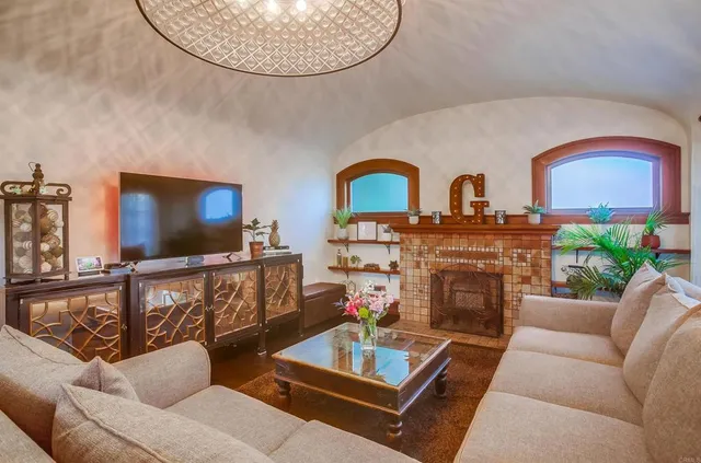 a living room with furniture a chandelier and a window