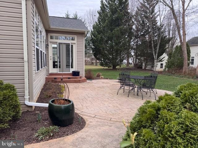 1733 Dearbought Drive Frederick, MD 21701 - Photo 6 of 7 a view of a patio with table and chairs potted plants and large tree