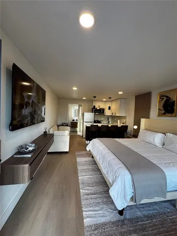 a large bedroom with a bed and a large window