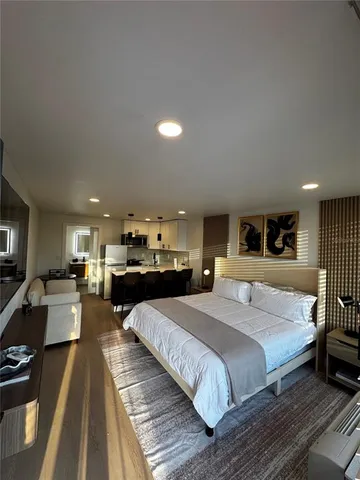 a bedroom with two beds and a flat screen tv