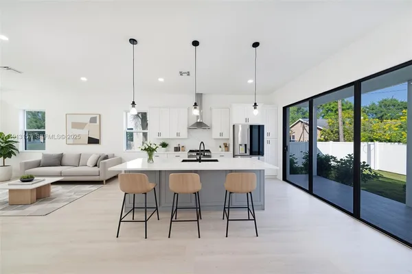 a living room with lots of furniture and a wooden floor