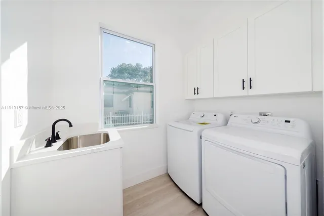 a view of storage and utility room with washer and dryer