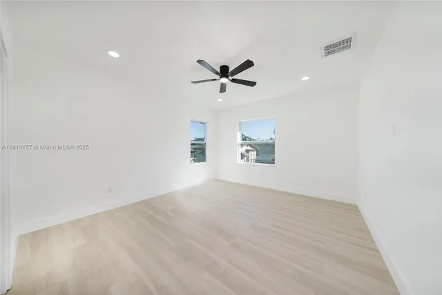 an empty room with a ceiling fan and a ceiling fan