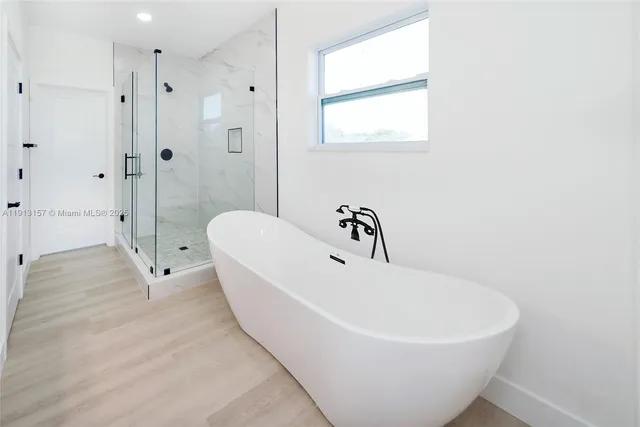a white bath tub sitting next to a white sink