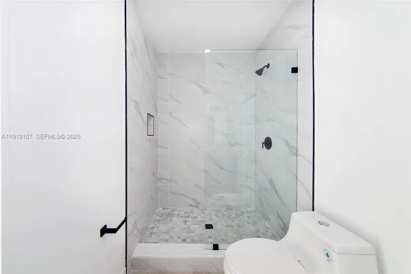 a bathroom with a toilet and shower