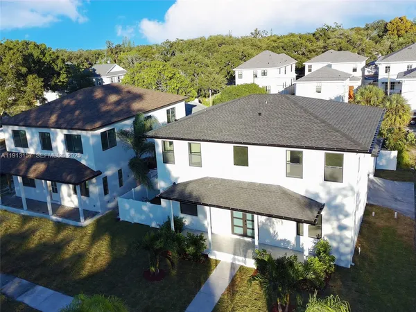 a aerial view of a house with swimming pool and a yard