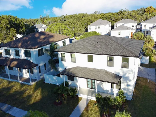 a aerial view of a house with swimming pool and a yard
