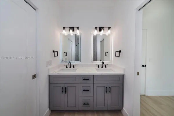 a bathroom with double sink and mirror