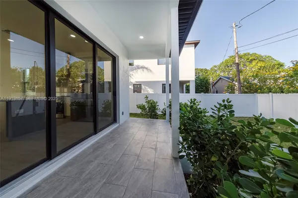 a view of a back yard from a corridor