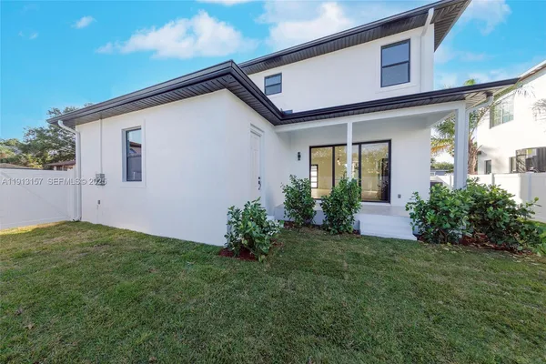 a view of an house with backyard space and garden