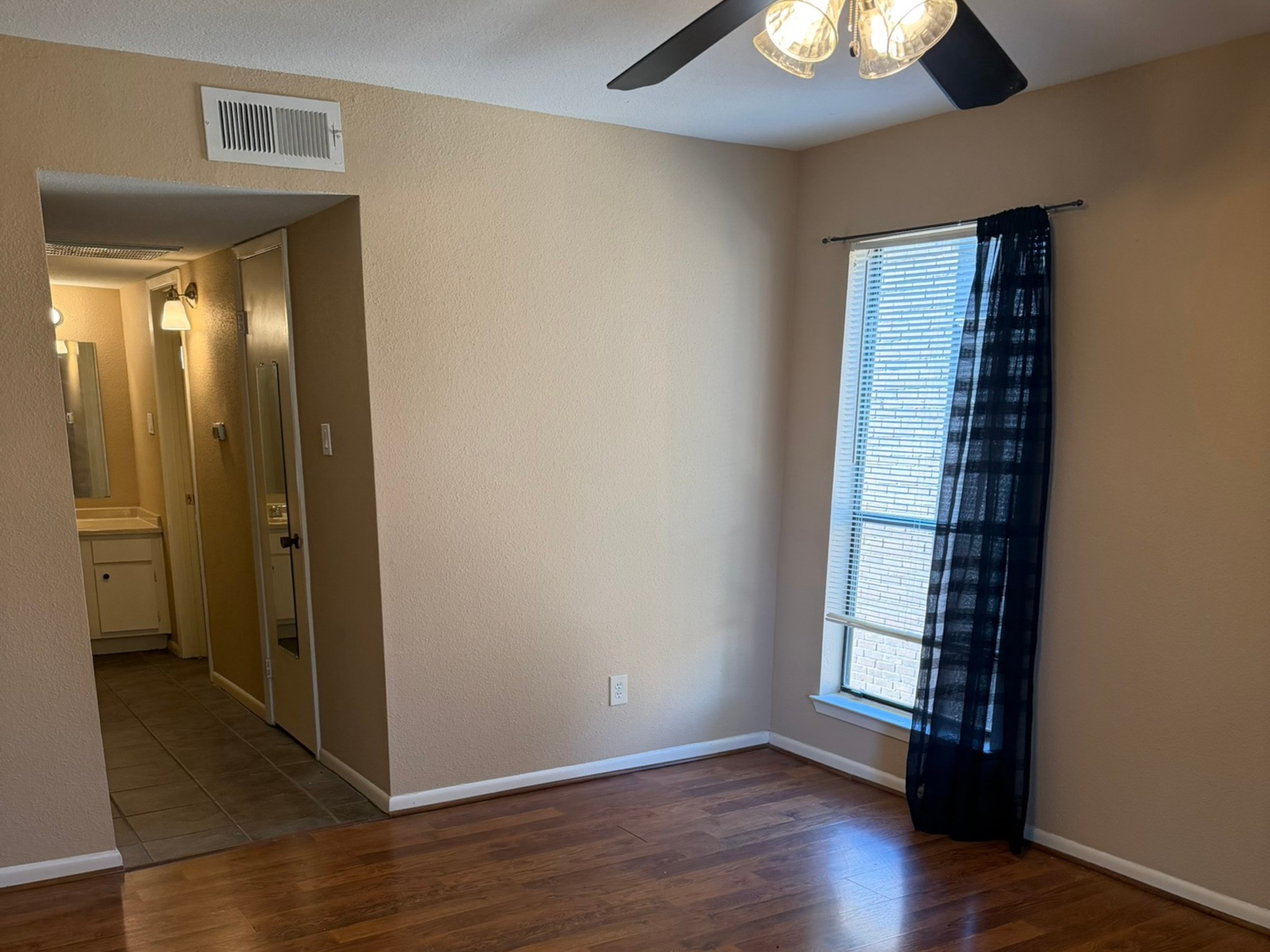 9000 Bissonnet Street, Unit 512 Houston, TX 77074 - Photo 6 of 13 wooden floor in an empty room with a window