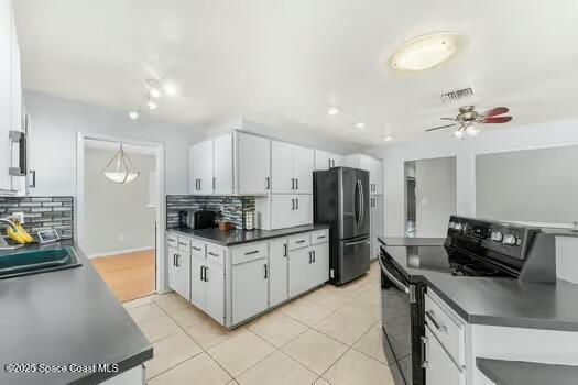 933 Waialae Circle Northeast Palm Bay, FL 32905 - Photo 11 of 32 a kitchen with stainless steel appliances kitchen island granite countertop a stove and a refrigerator
