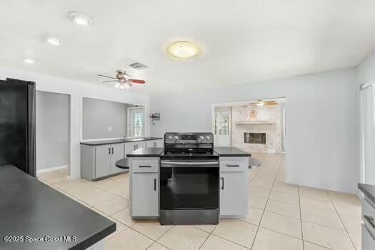 933 Waialae Circle Northeast Palm Bay, FL 32905 - Photo 12 of 32 a kitchen with a stove top oven and cabinets