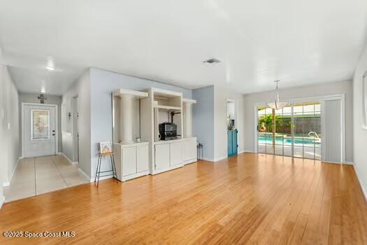 933 Waialae Circle Northeast Palm Bay, FL 32905 - Photo 16 of 32 a view of an entryway with wooden floor and a living room